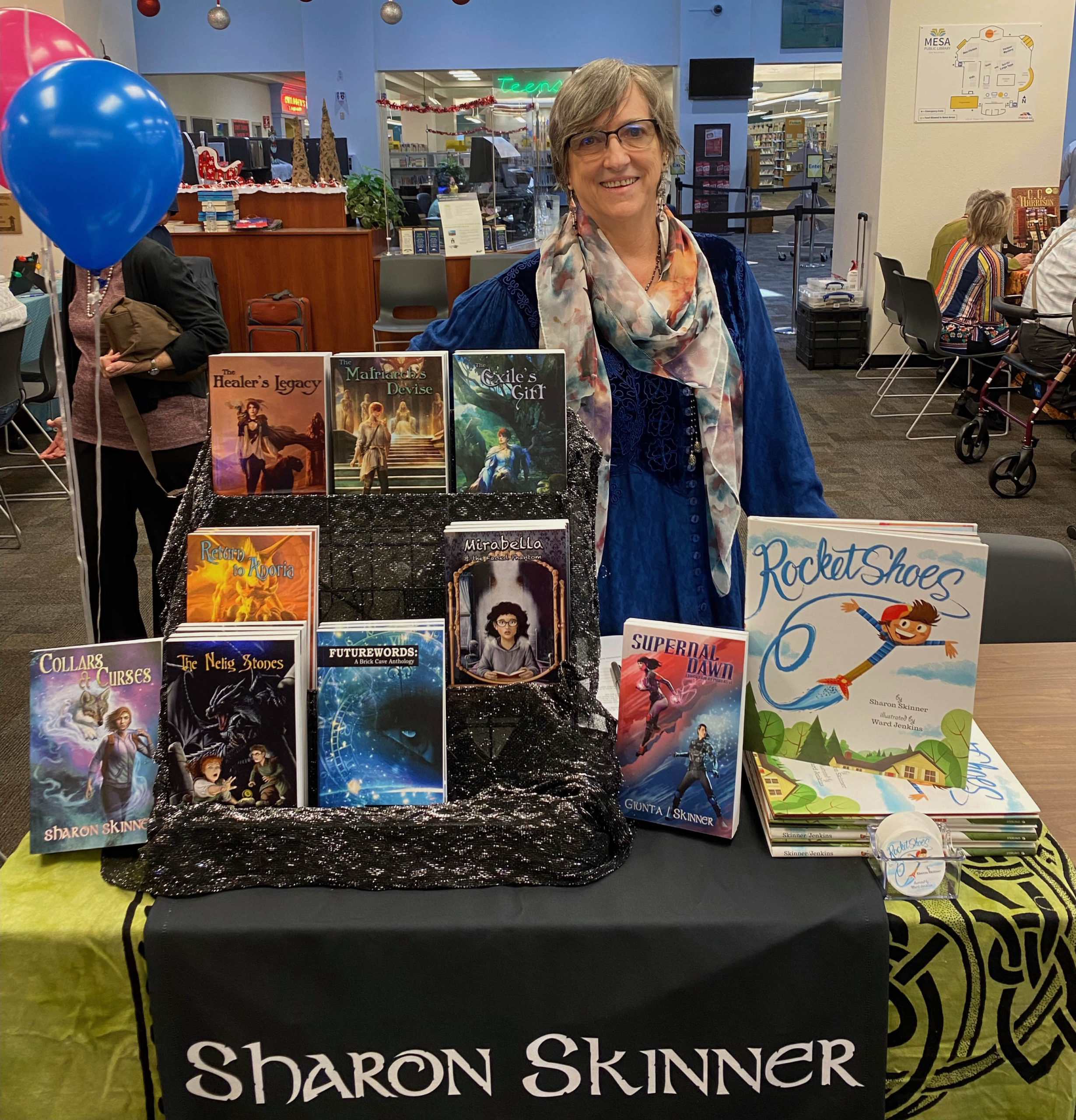 Sharon Skinner standing behind book display at one of her local appearances.