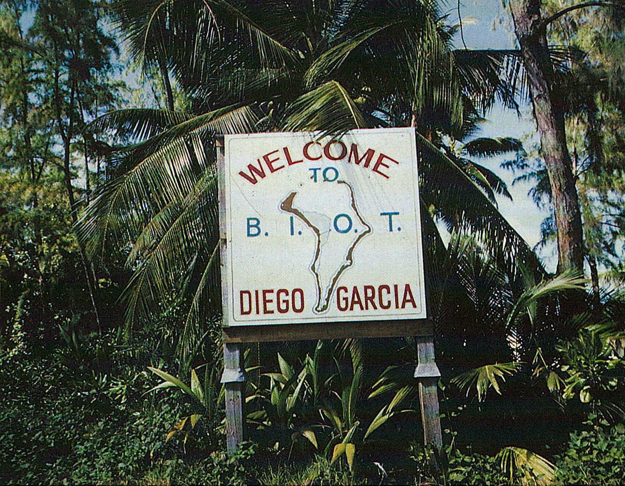 Sign surrounded by jungle foliage: Welcome to Diego Garcia, B.I.O.T