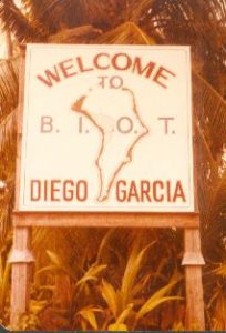 Sign surrounded by foliage: Welcome to Diego Garcia, B.I.O.T