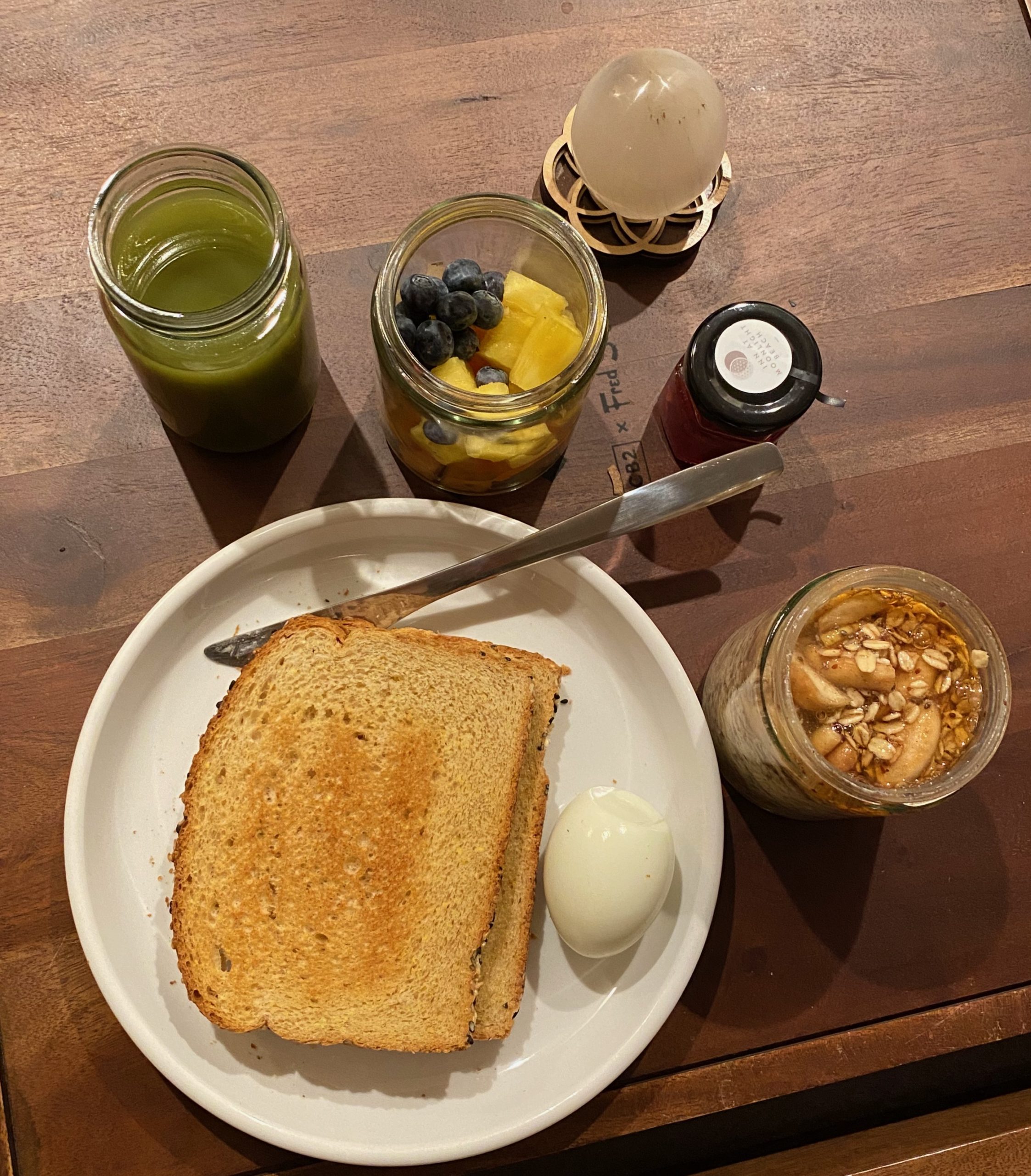 Locally Sourceed Breakfast at the Inn at Moonlight Beach at Encinitas, CA: Green juice, Whole-grain toast,egg, fresh fruit, overnight oats with apples andhoney and apple jelly