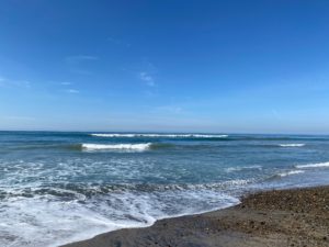 Moonligh Beach at Encinitas with small waves under blue sky