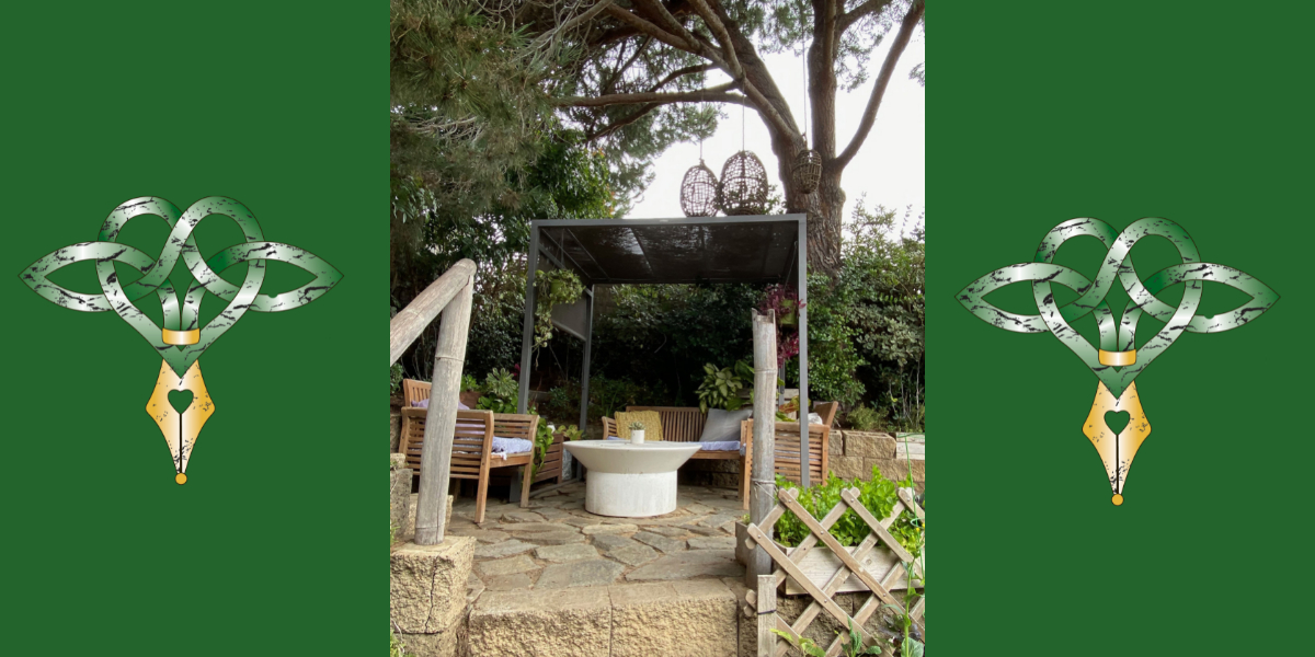 Part of my Mini-Writing Retreat: Covered seating at top of stairs in organic garden at the Inn at Moonlight Beach, Encinitas, CA Green borders with Author Logo ofgreen Celtic heart with gold pen nib